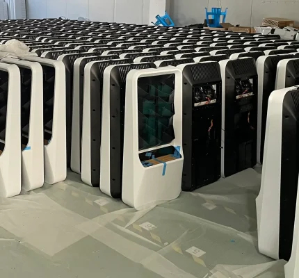 Multiple assembled monitors in organized rows.